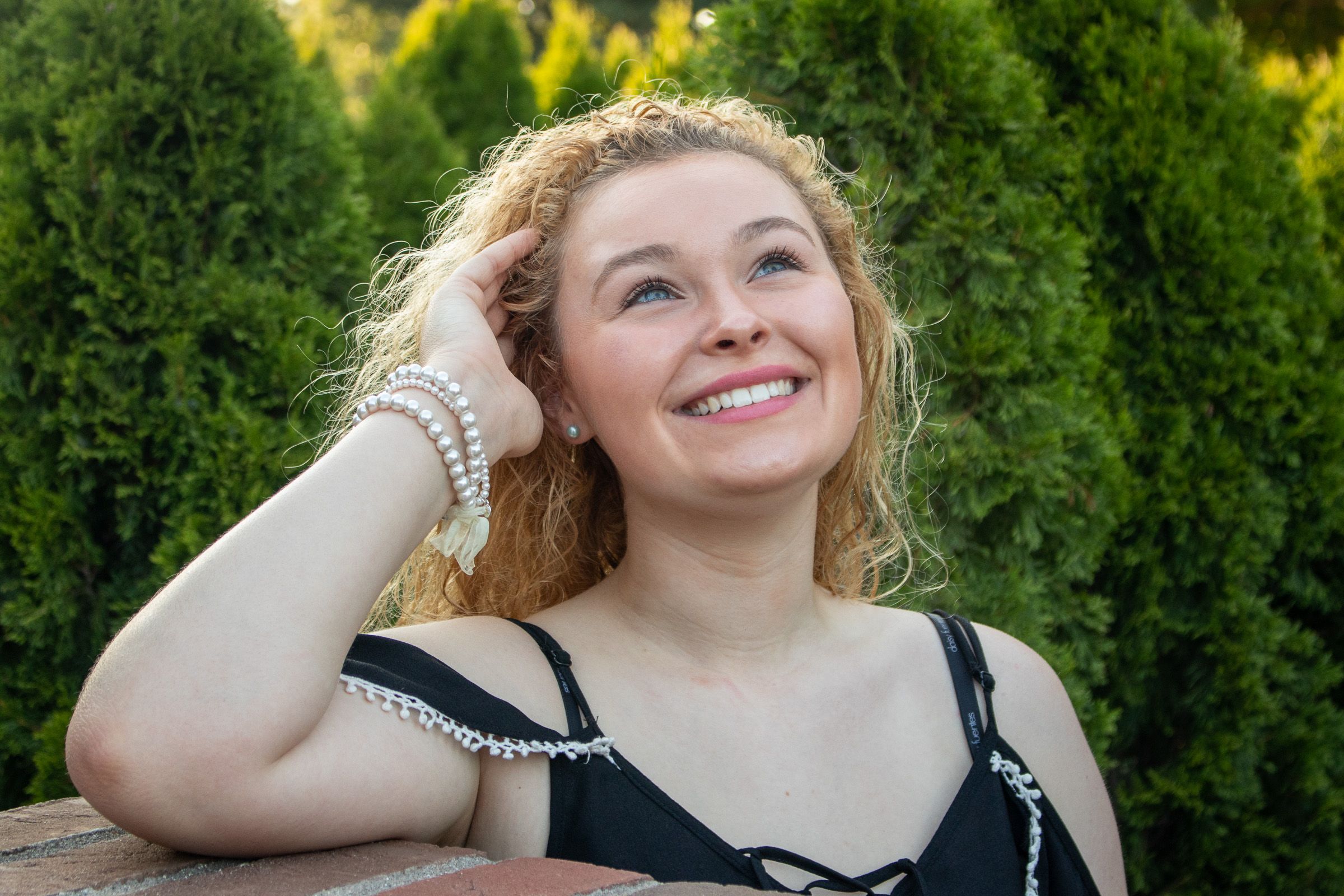 Senior portrait in profile with curly hair