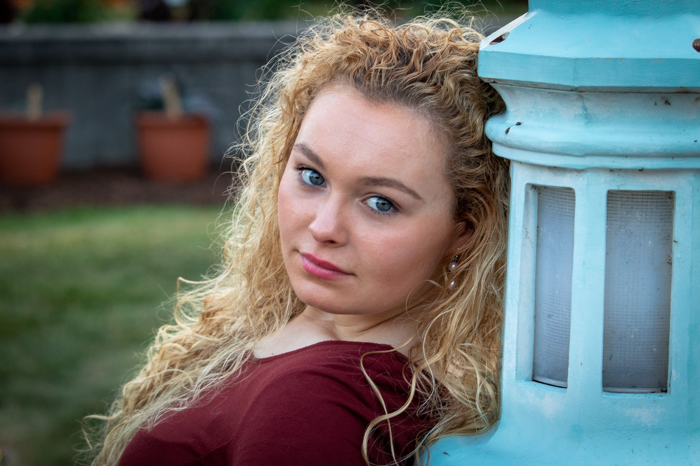 Senior portrait next to a teal lantern